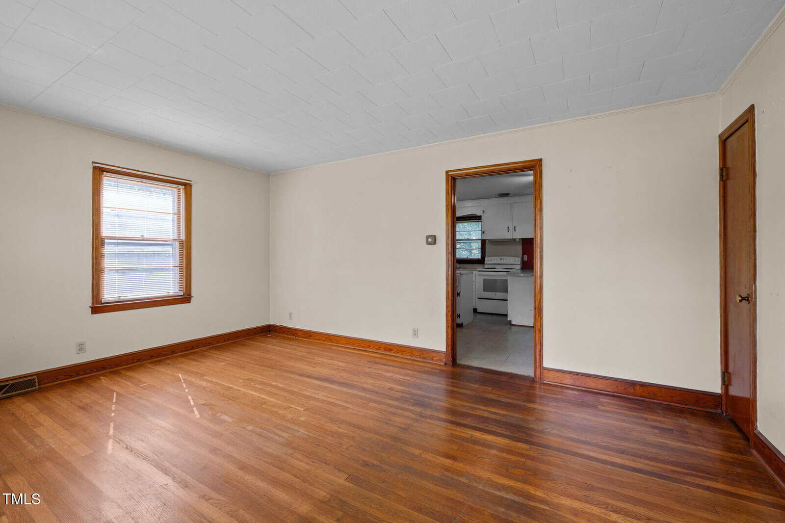 A room with a wood floor and a door.