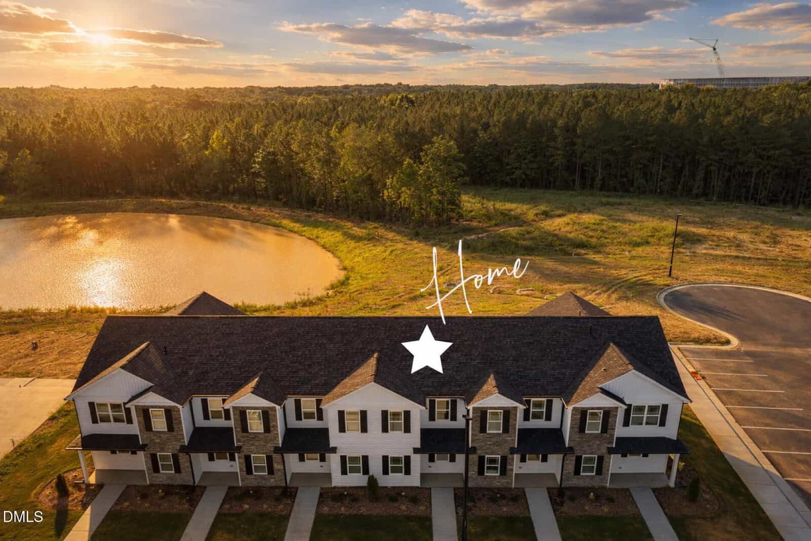 A row of townhomes in Oxford is shown from above at sunset, with a pond and trees in the background. A white star and the word "Home" highlight 1104 Brookrun Drive in the center of the building.