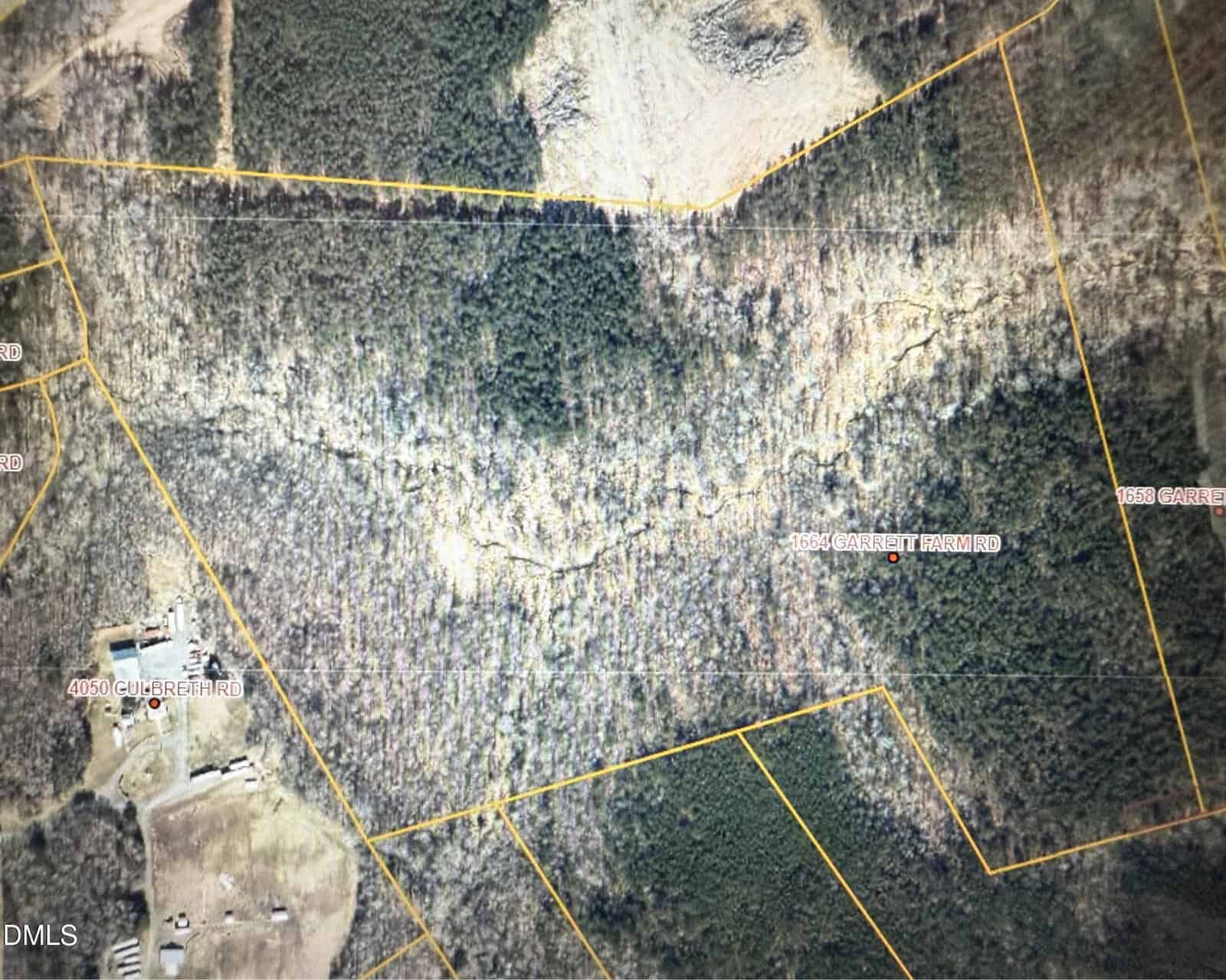 A satellite map view showing forested land divided by yellow boundary lines, with labeled locations including Stem and 1664 Garrett Farm Road, as well as roads like Churchett Road and Garrett Hamm Road winding through wooded areas and clearings.