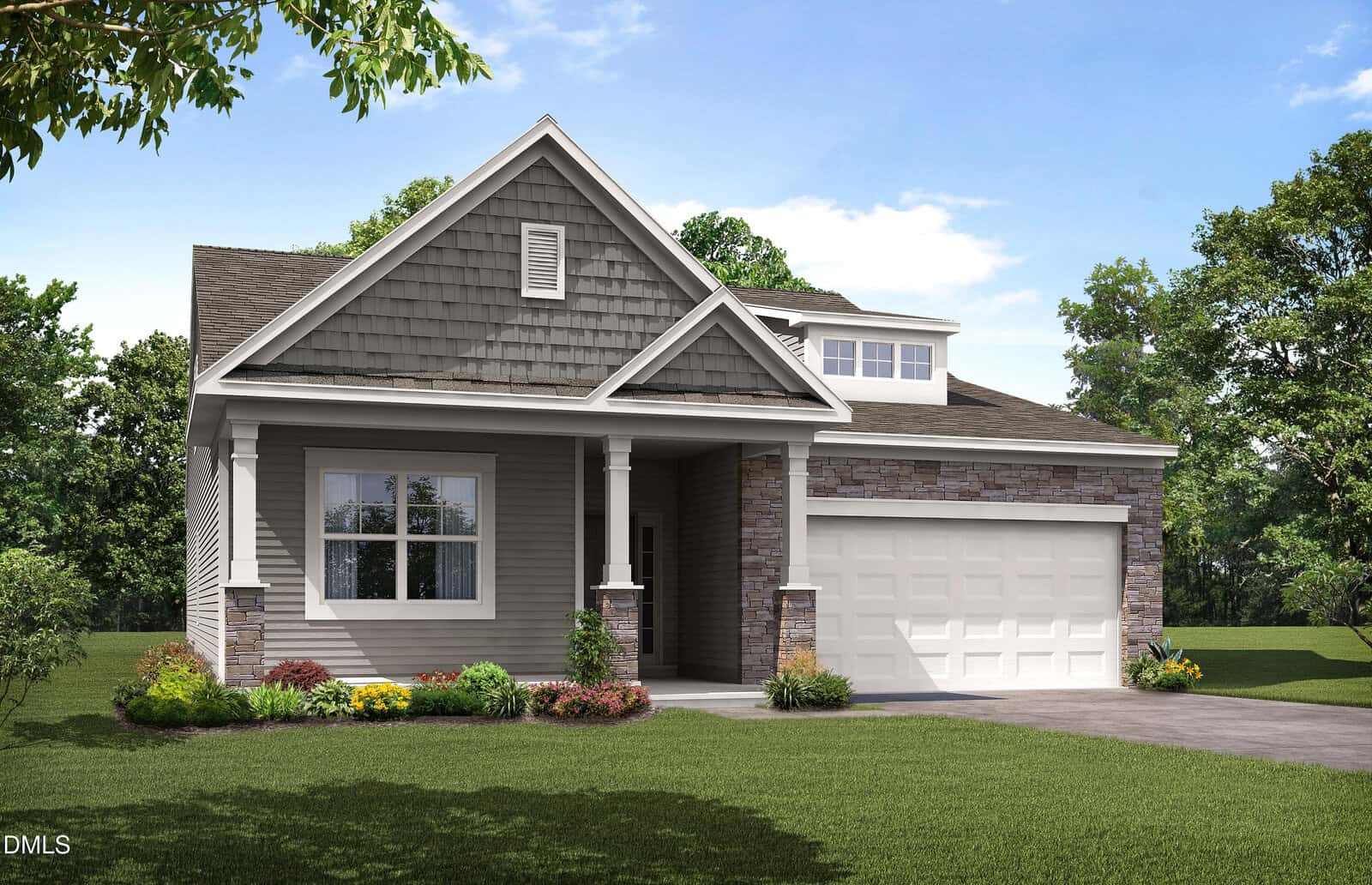 Single-story suburban house with gray siding and stone accents, a covered front porch with columns, neatly trimmed bushes and yellow flowers in front, and a two-car garage. The lawn is green and surrounded by trees.