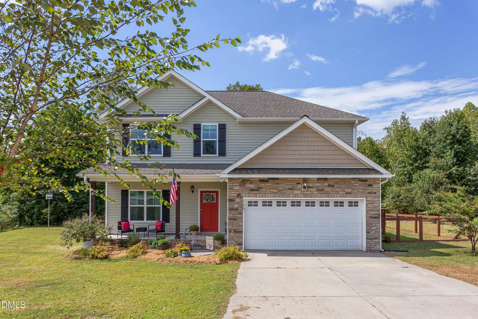 A charming house with a red door and a driveway located at 1146 Country Club Lane in Zebulon.