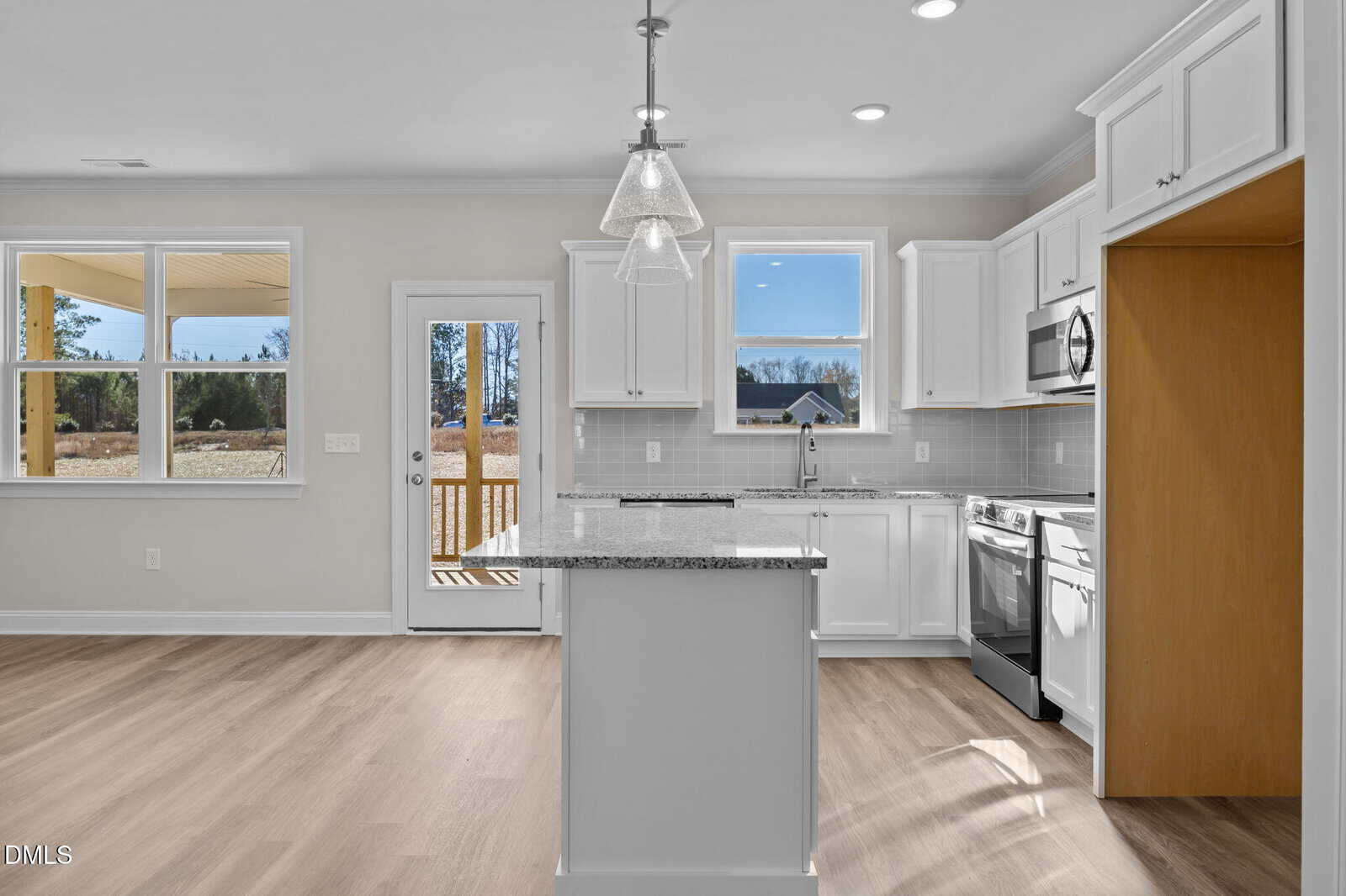 A kitchen with a island and a wood floor.