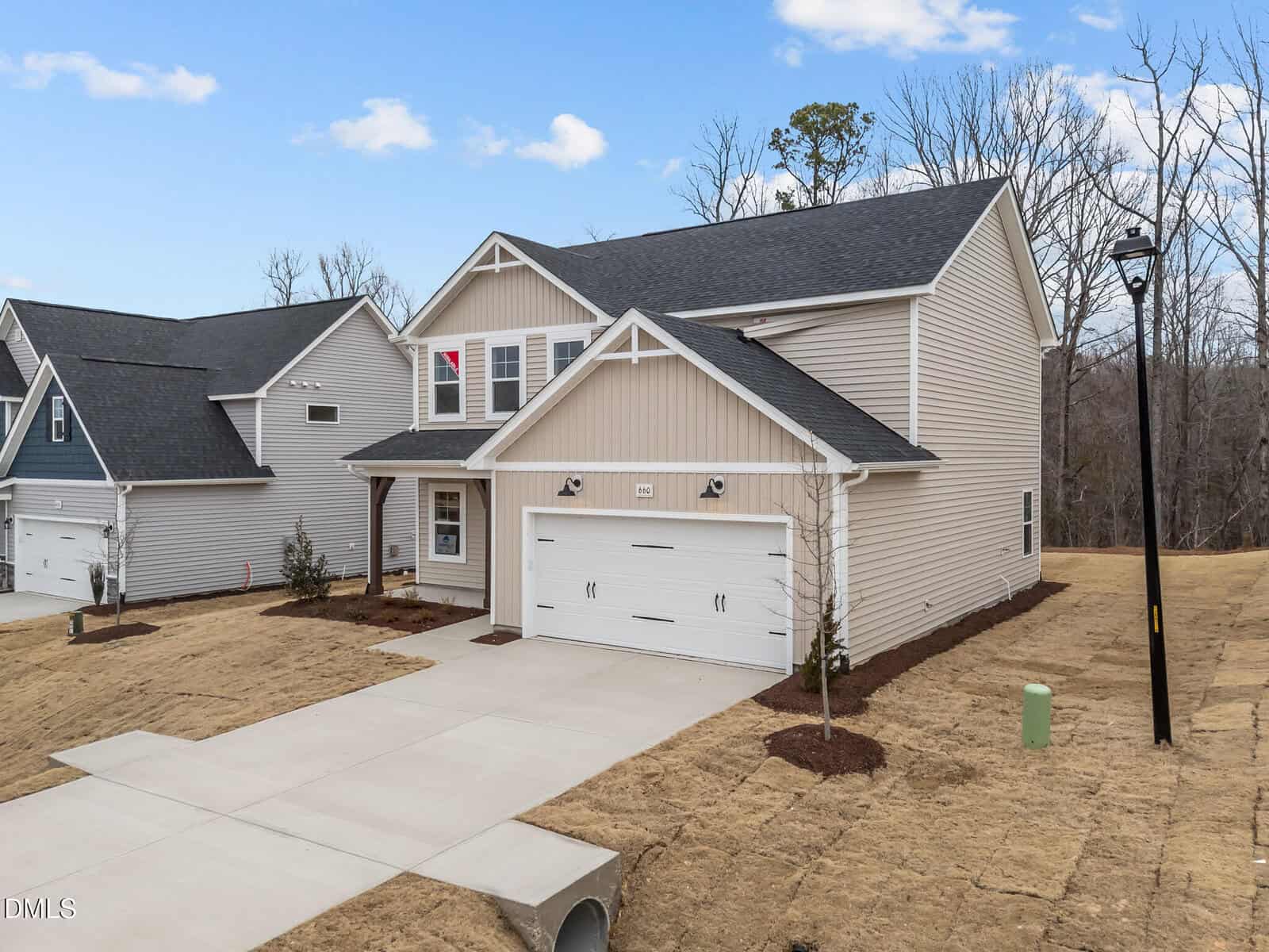 Modern house with garage and landscaped yard.