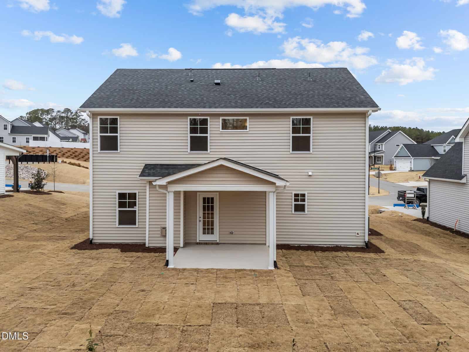 New suburban house with gray exterior and yard.