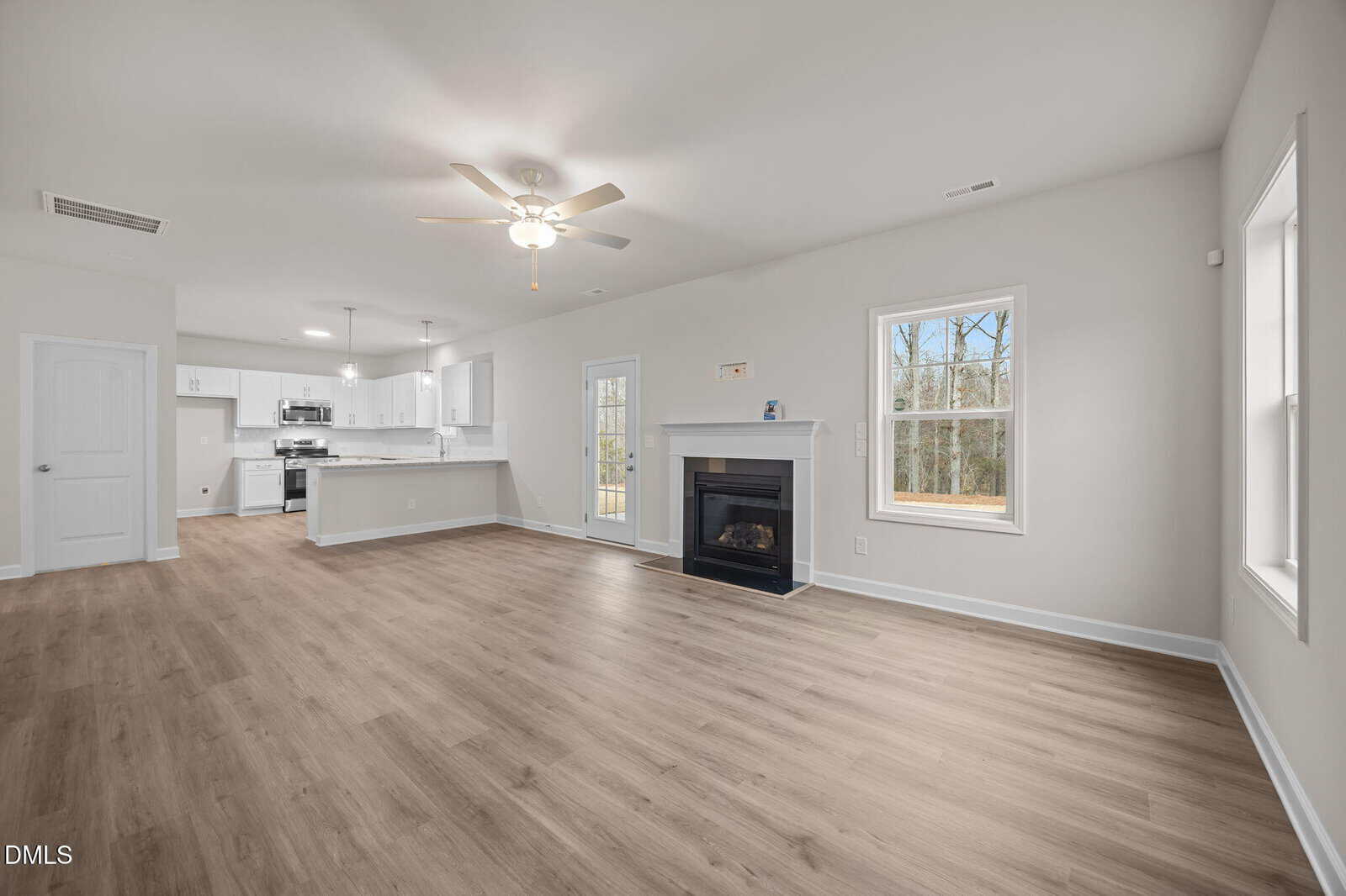 Open living area with kitchen and fireplace.