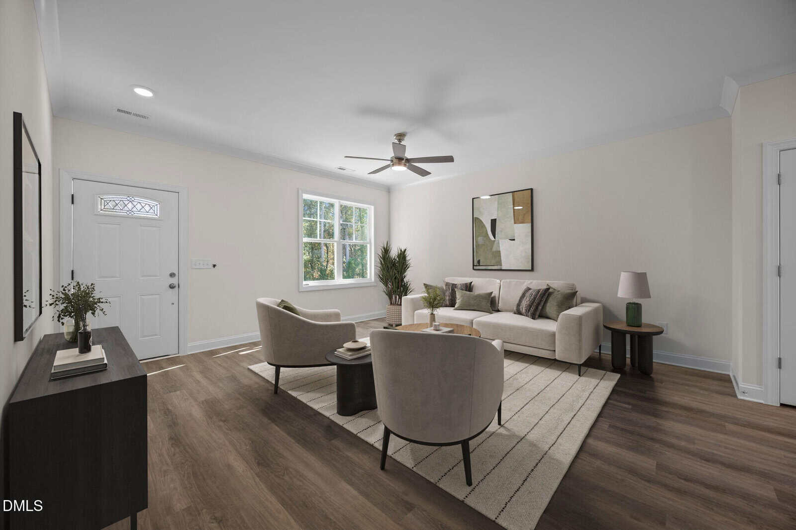 A modern living room with light walls and wood flooring, featuring a beige sofa, two light armchairs, a coffee table, a large rug, a sideboard, potted plants, and artwork on the wall. Sunlight streams in from a window.