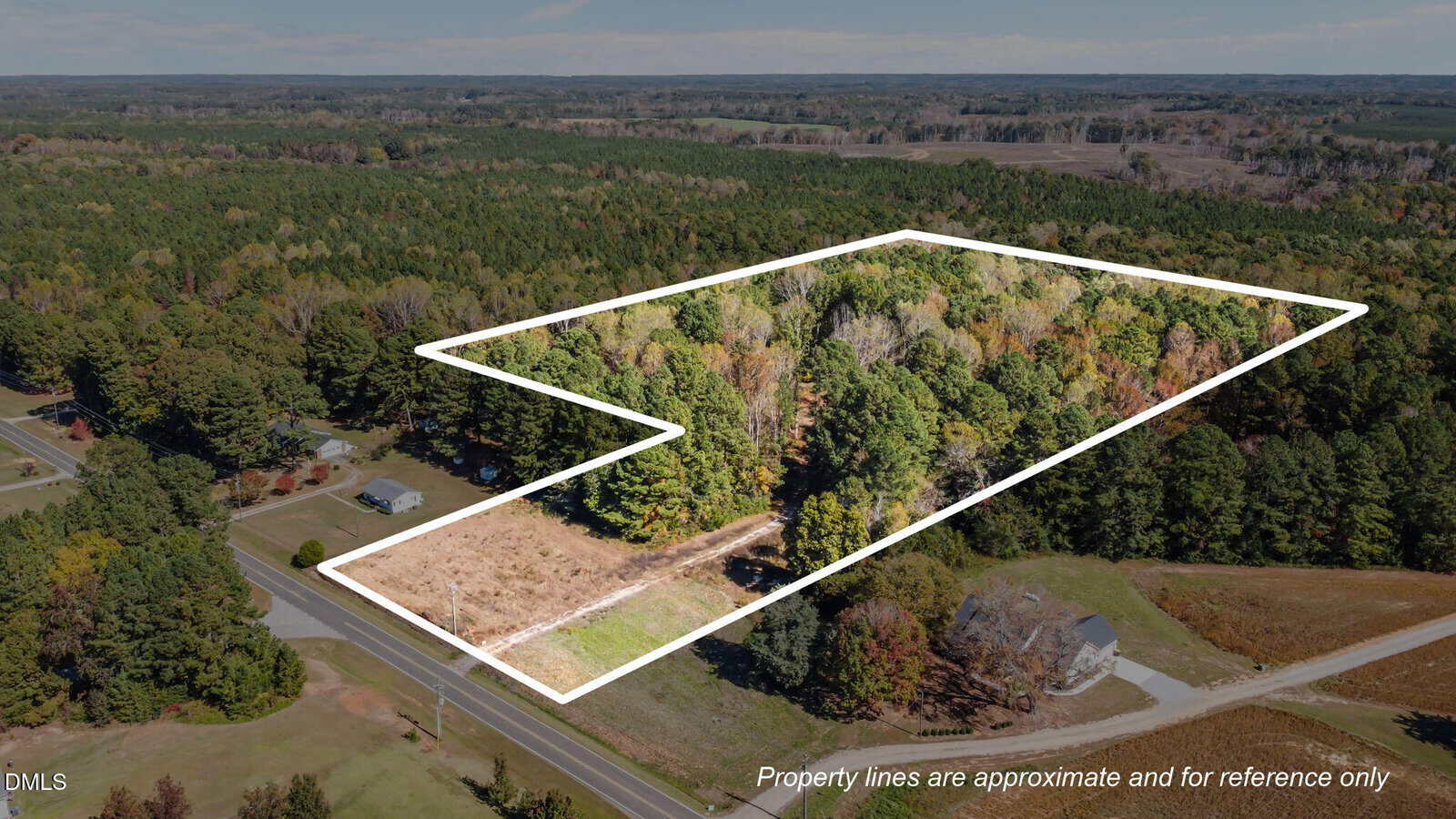 Aerial view of wooded property at 3652 Cannady Mill Road, Kittrell, with approximate boundary lines highlighted in white. Surrounded by trees and open land, with a road and a few houses nearby. Boundaries are for reference only.