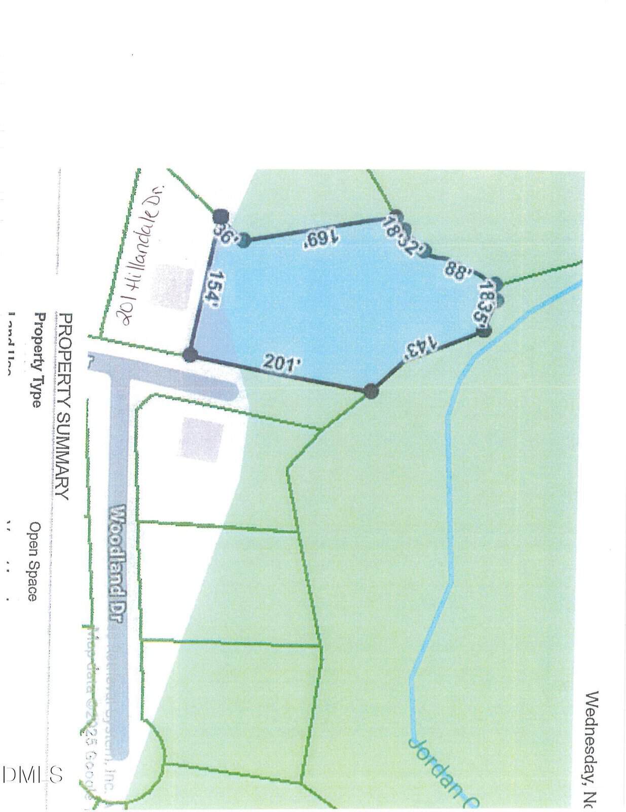 A map showing a property outlined in blue near Woodland Dr, bordered by water, with labeled boundary lengths and nearby green areas marked as Jordan Creek.