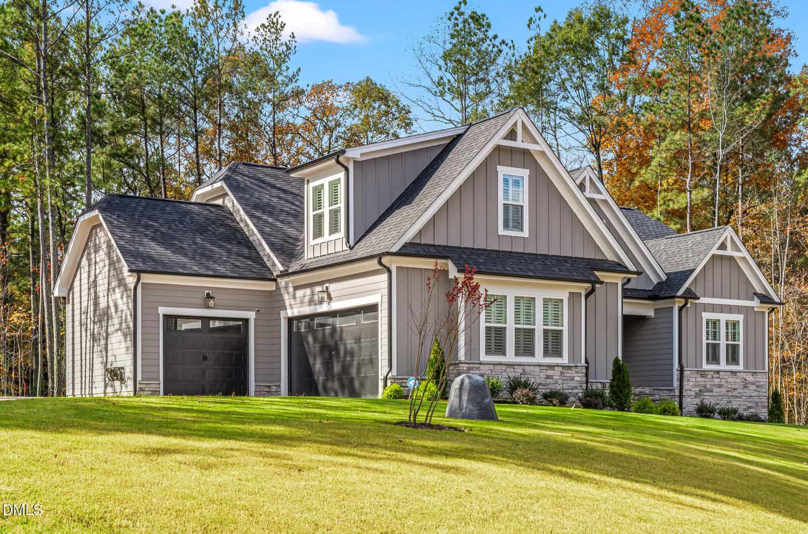 A house with a lawn and trees in the background.