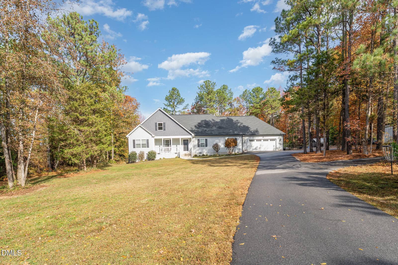 A house with a driveway and trees.