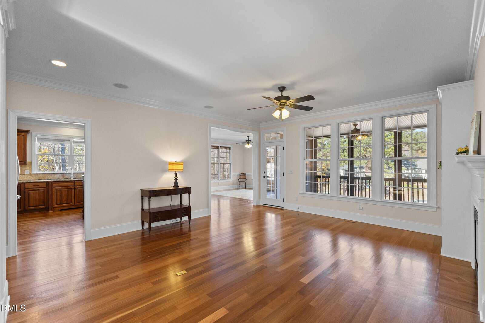 A room with hardwood floor and ceiling fan.
