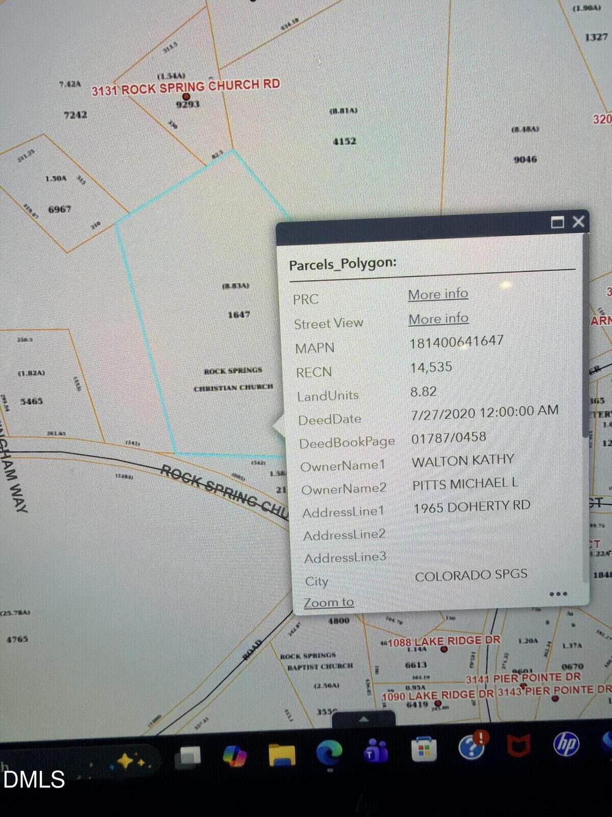 A computer screen displays a parcel map with property boundaries highlighted. An information box shows parcel details, including owner's name, land units, address, and relevant deed and property information.