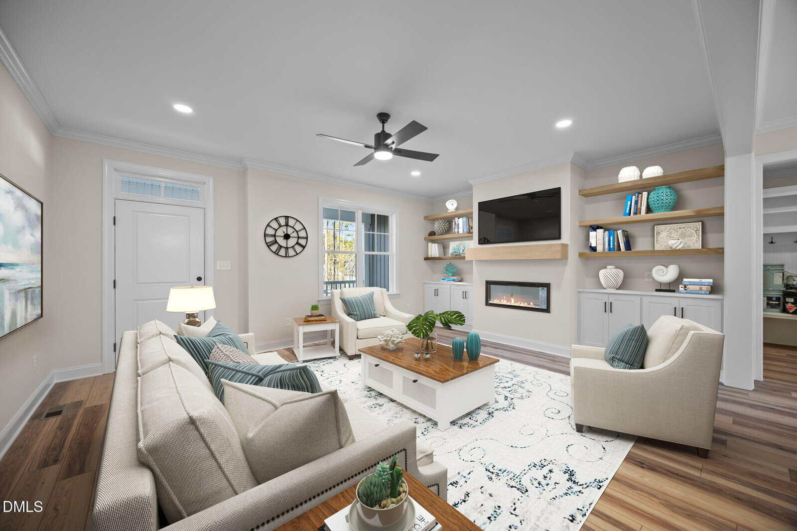A bright, modern living room with beige walls, a ceiling fan, a built-in fireplace, a wall-mounted TV, shelves with decor, a gray sofa, two armchairs, a wooden coffee table, and large windows letting in natural light.