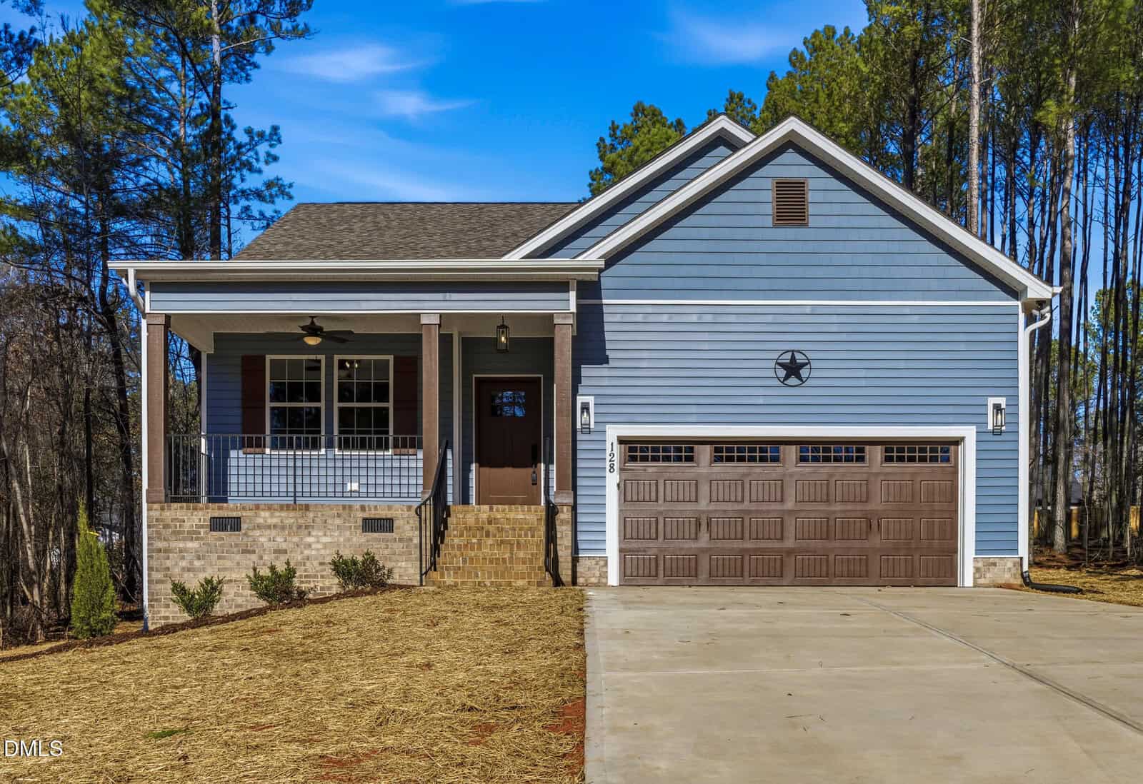 A charming house at 128 Wichita Way in Louisburg featuring a spacious driveway and inviting curb appeal.