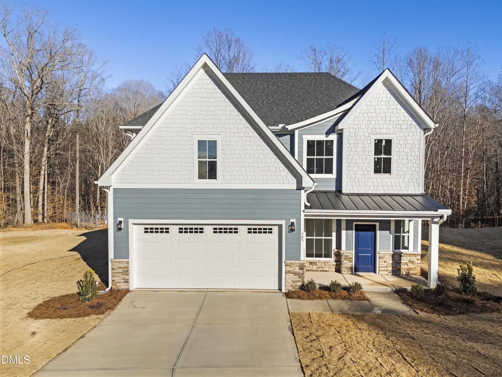 Located at 165 Vast View Way in Youngsville, this two-story house features light gray and white siding, a dark gray roof, blue front door, and a two-car garage on a large lot with concrete driveway and sparse landscaping among leafless trees.