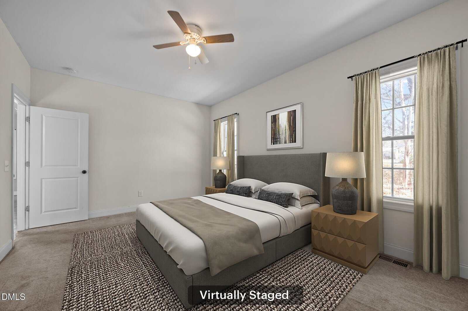 A modern bedroom with a large bed, two nightstands with lamps, a ceiling fan, two windows, and neutral-colored decor. Text at the bottom reads “Virtually Staged.”.