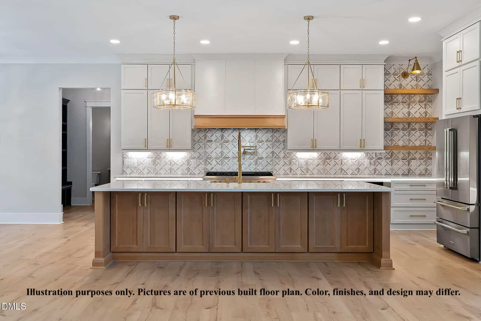 Modern kitchen with white upper cabinets, a wood-trim island, stainless steel appliances, patterned backsplash, two gold pendant lights, and wood shelving. Light wood floors and neutral colors throughout.