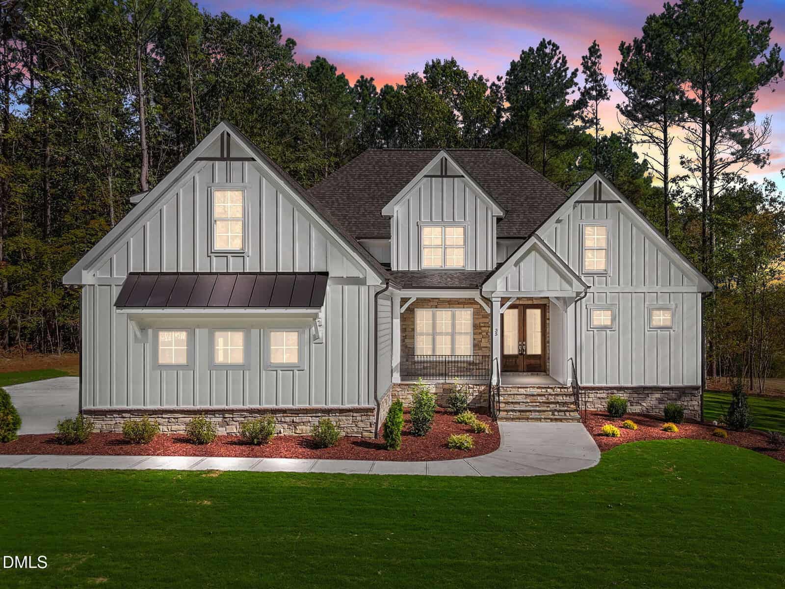 A modern farmhouse-style home at 35 Broadleaf Lane in Youngsville features light gray vertical siding, a dark roof, covered porch, stone accents, and a landscaped front yard, all set against a picturesque backdrop of trees at sunset.