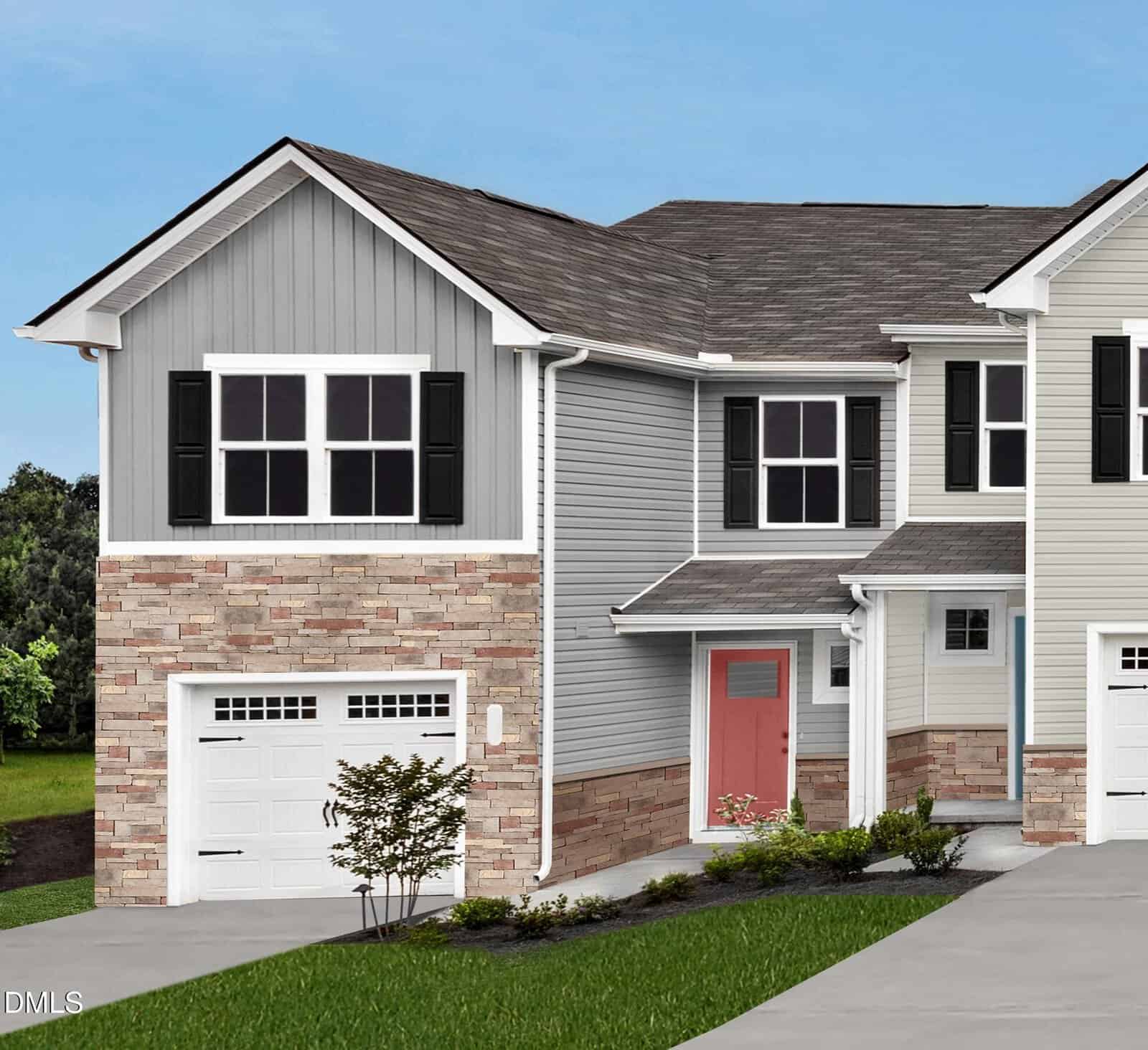 A charming two-story townhouse at 1172 Robins Nest Drive in Youngsville features gray siding, stone accents, black shutters, a white garage door, and a striking red front door. Shrubs and small plants line the walkway, with green grass and trees in the background under a blue sky.