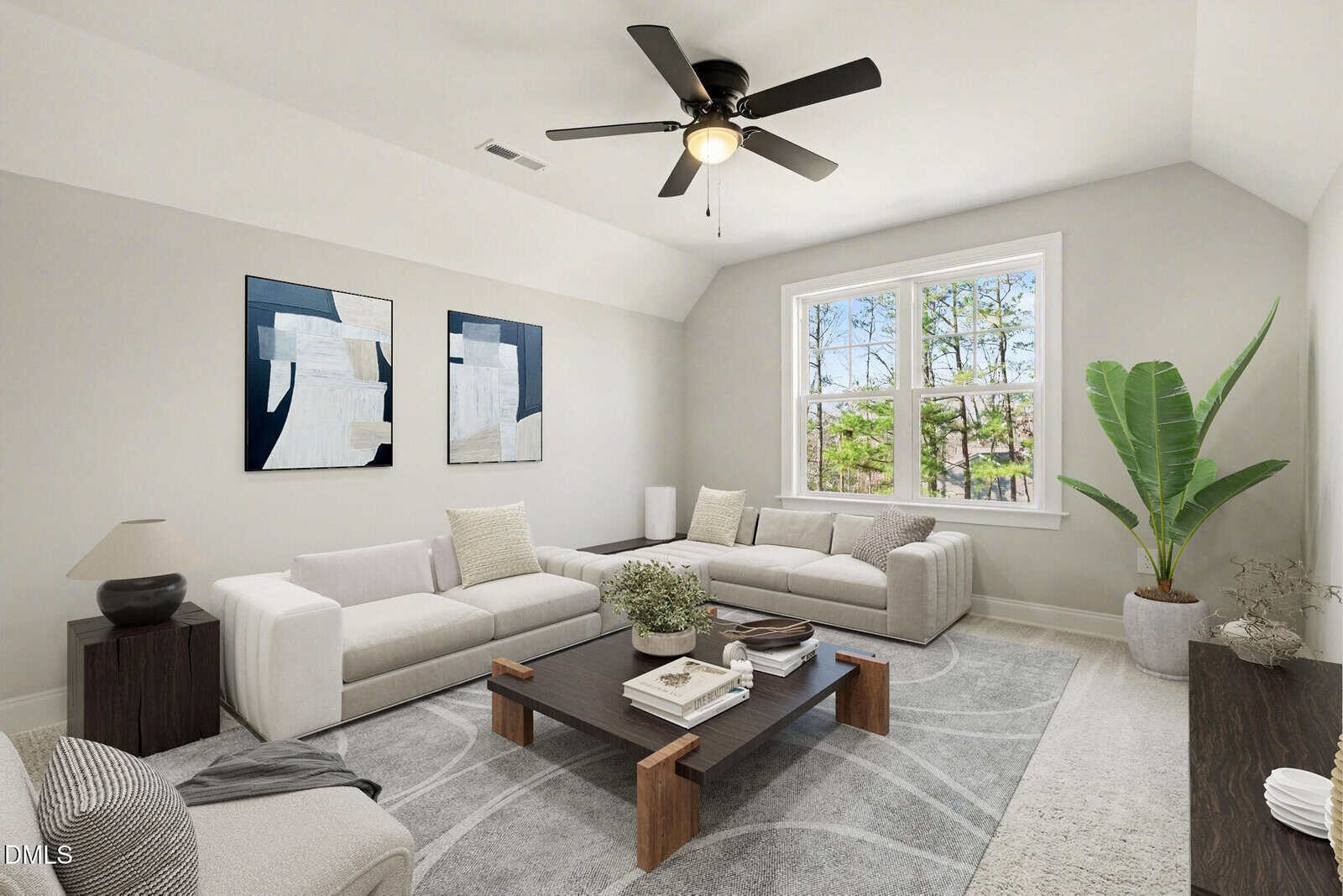Bright living room with two white sofas, a large window, a ceiling fan, abstract wall art, a wooden coffee table with decor, a potted plant, and neutral-toned furnishings on a patterned gray rug.