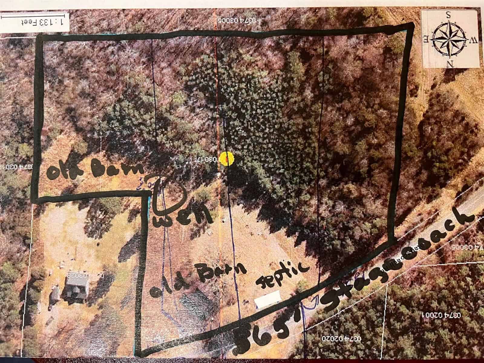 Aerial map with a black-outlined property boundary, labeled “old barn,” “well,” “septic,” and “36ft stagecoach,” plus trees, a structure, and a north arrow. Handwritten notes mark features within the wooded and cleared areas.