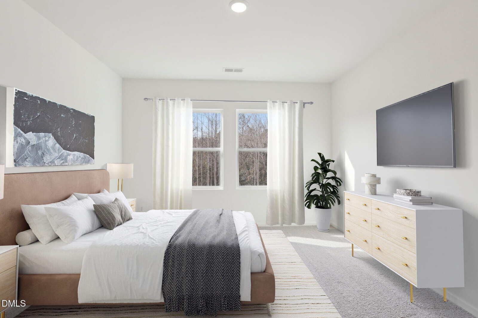 Bright bedroom with a large bed, gray blanket, white dresser, flat-screen TV, potted plant, and windows with sheer curtains letting in natural light.