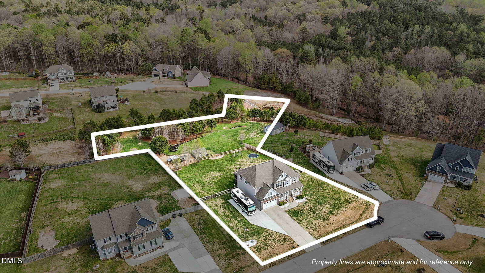 Aerial view of a suburban neighborhood, with one property outlined in white. The property includes a large house, driveway, RV, lawn, and backyard, surrounded by other homes and trees. Text notes property lines are approximate.