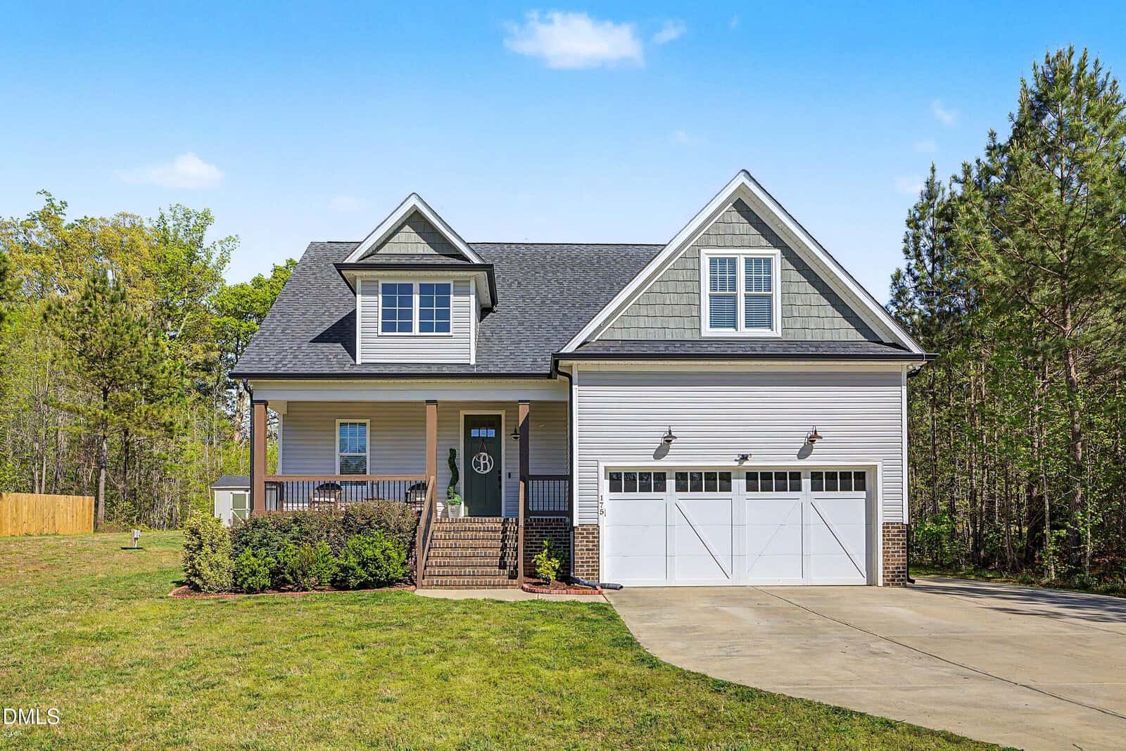 A two-story suburban house at 175 Sorrel Drive in Franklinton features gray siding, white trim, a covered front porch, and a double garage. The lawn is green and well-kept, with a concrete driveway leading up to the home. Mature trees surround the property in the background.
