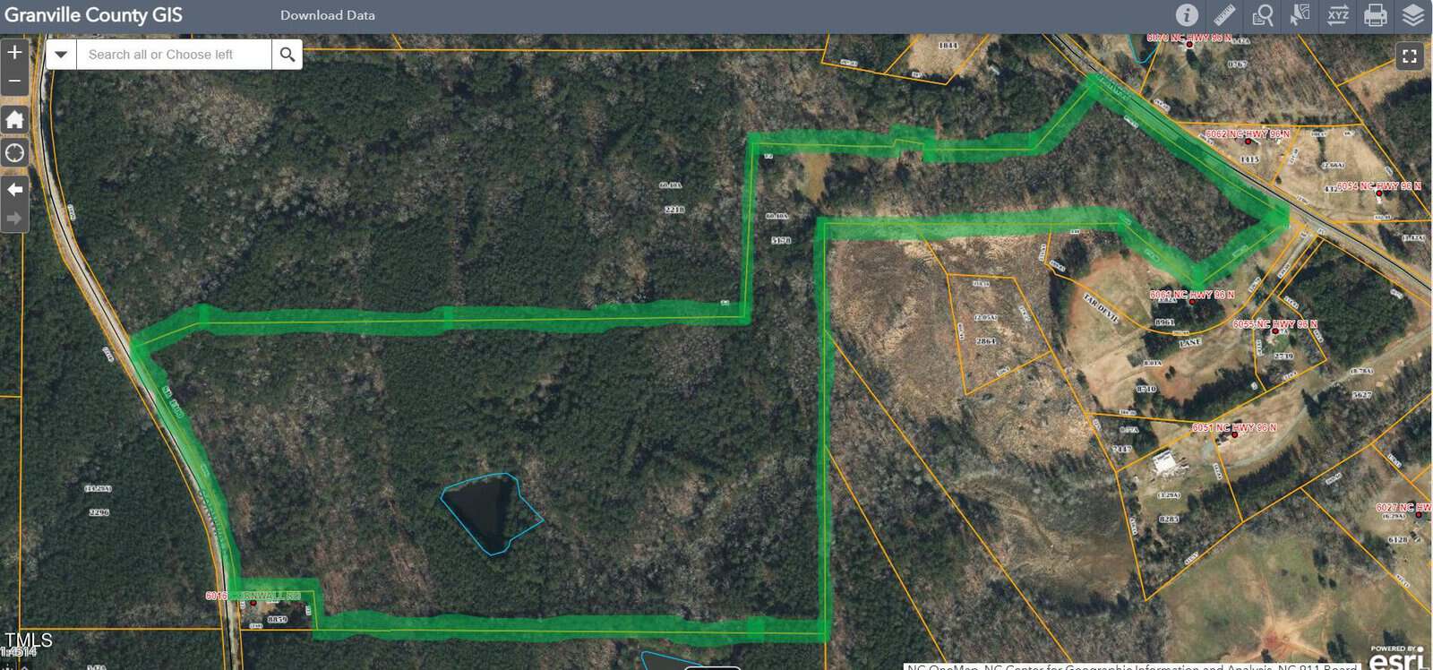 A satellite map from Granville County GIS shows a green highlighted boundary outlining a wooded area and adjacent properties, with surrounding roads, parcels, and some buildings visible on the right side.