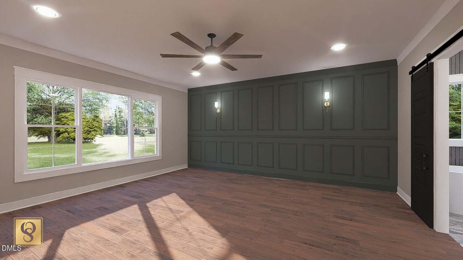 Empty room with wood floor, large windows on the left, a green accent wall with paneling and two wall sconces, a ceiling fan with lights, neutral-colored walls, and a sliding barn-style door on the right.