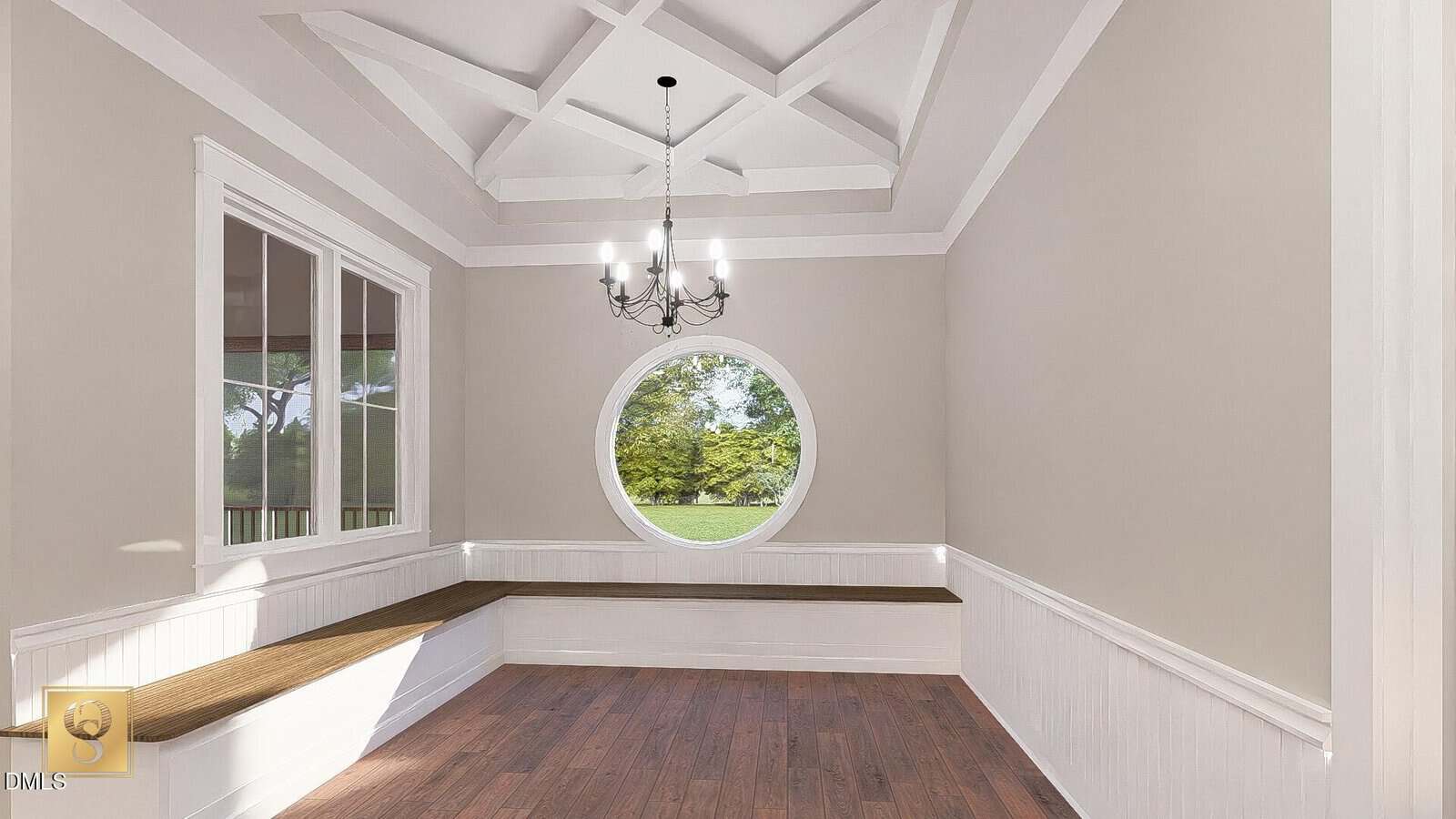 Bright room features a circular window, built-in bench seating with wood tops along two walls, a wooden floor, beige walls with white trim, and a coffered ceiling with a black chandelier.