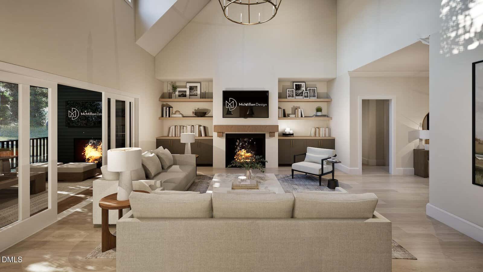 A modern living room with a high ceiling, light-colored furniture, built-in shelves, a fireplace, and large windows letting in natural light. A television is mounted above the fireplace, and a chandelier hangs from the ceiling.