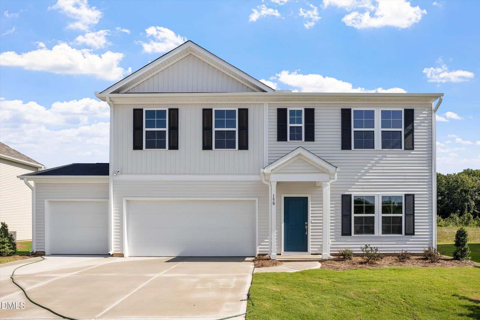 Two-story suburban house with white siding, black shutters, a blue front door, and a three-car garage nestled at 150 Buckthorn Drive in Youngsville. The driveway and small landscaped area are visible, framed by a clear blue sky with some clouds in the background.
