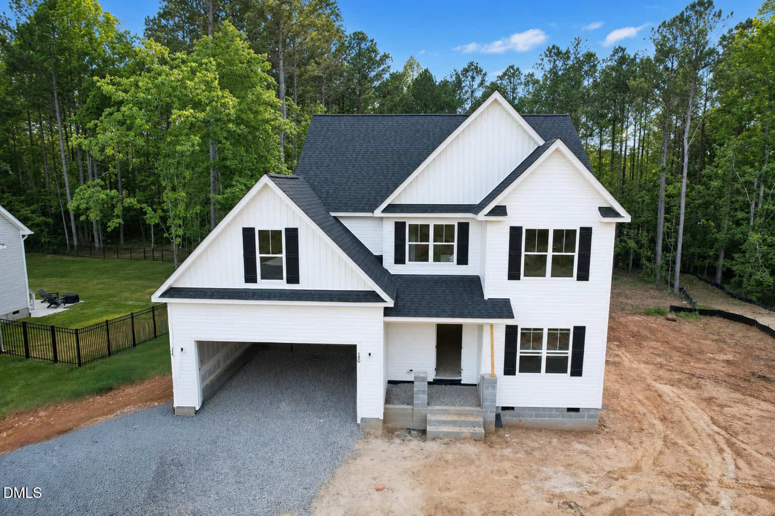 A newly built two-story white house with black roof shingles at 190 Purslane Drive in Franklinton, featuring an attached double garage, front porch, and a large, partially landscaped yard with trees and a gravel driveway.
