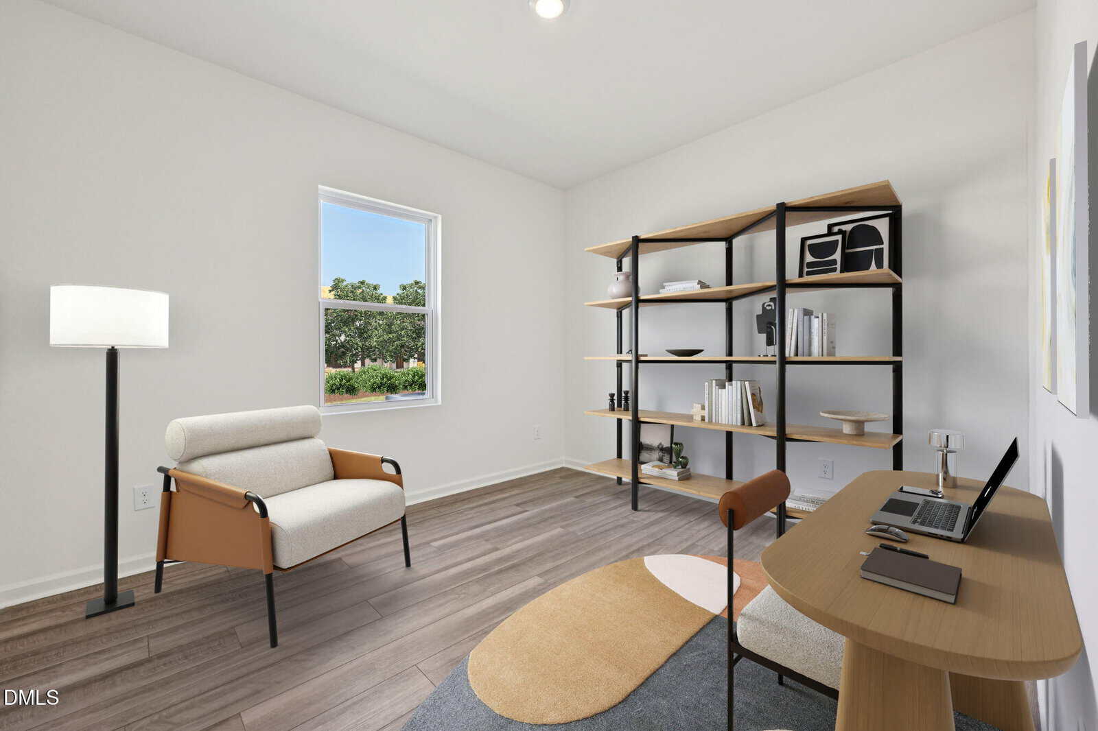 Minimalist home office with a modern armchair, floor lamp, open shelving with books and decor, a wooden desk with a laptop, and a window showing greenery outside. The room has light walls and wood flooring.