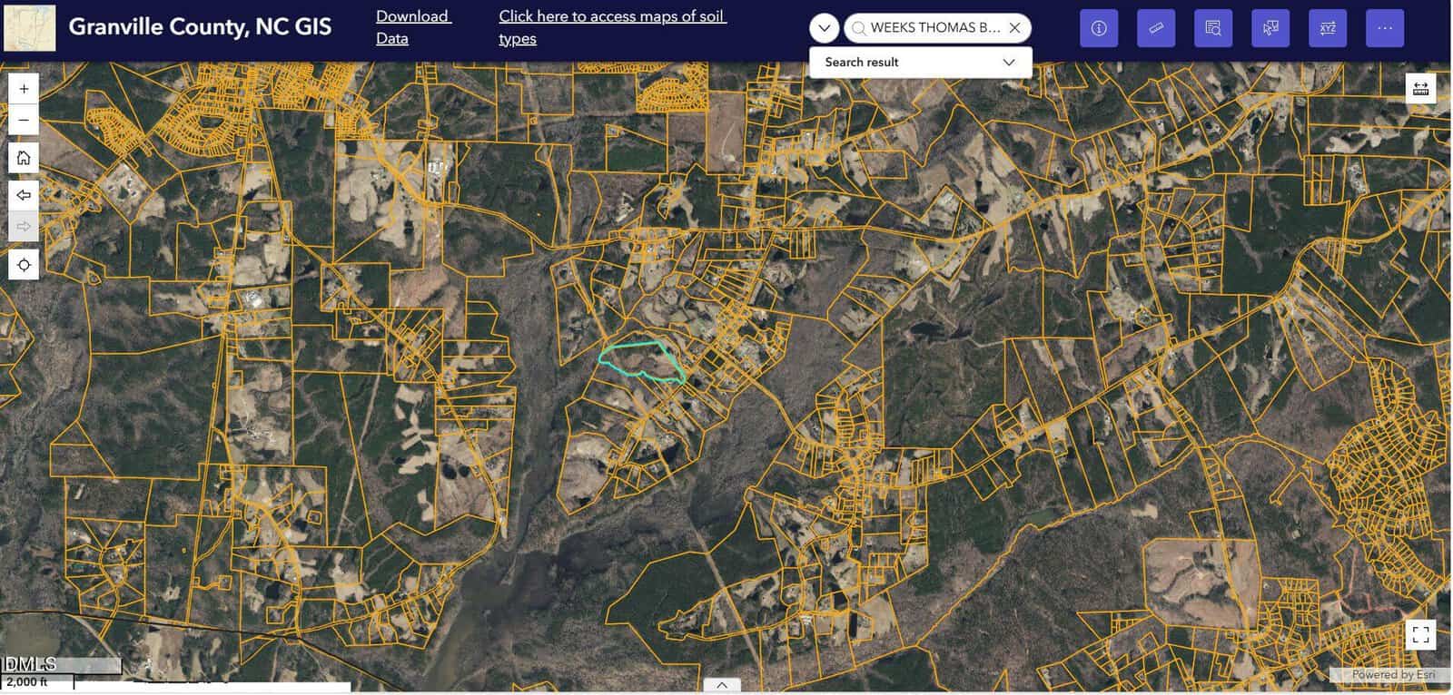 Aerial GIS map of Granville County, NC, showing property boundaries in yellow lines over a landscape of woods, fields, and roads, with a highlighted property near the center.