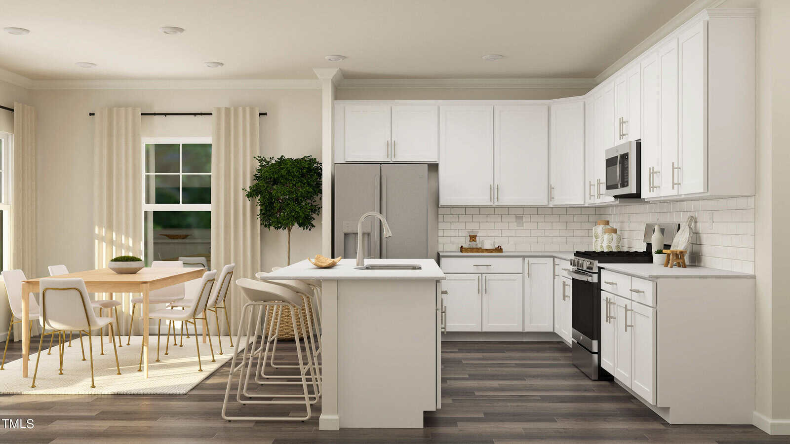 Modern kitchen with white cabinets, stainless steel appliances, a center island with barstools, and a dining area with a wooden table and chairs near a window with curtains and a large green plant.