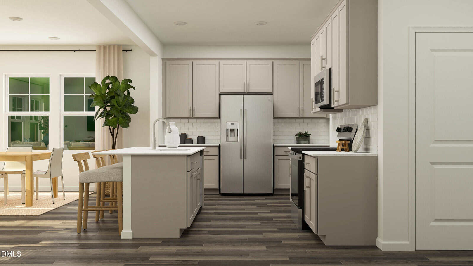 Modern kitchen with stainless steel appliances, light beige cabinets, white countertops, and wood flooring. A dining area with a wooden table and chairs is visible to the left, along with a large potted plant.