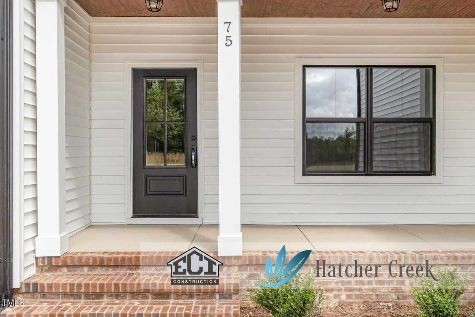 Front porch of a white house with a black door, brick steps, and a large window. Logos for ECI Construction and Hatcher Creek are visible in the bottom right corner.