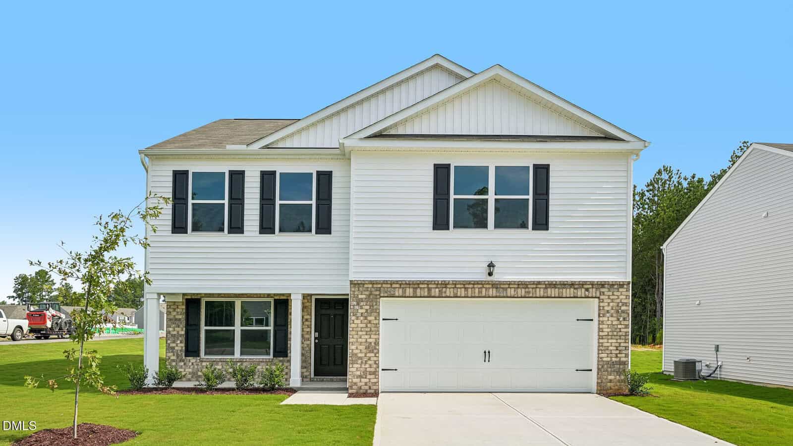 A two-story suburban house at 78 Richmond Run with white siding, black shutters, and a double garage. The front features a small lawn, a young tree stem, and driveway, all set against a clear blue sky in the background.