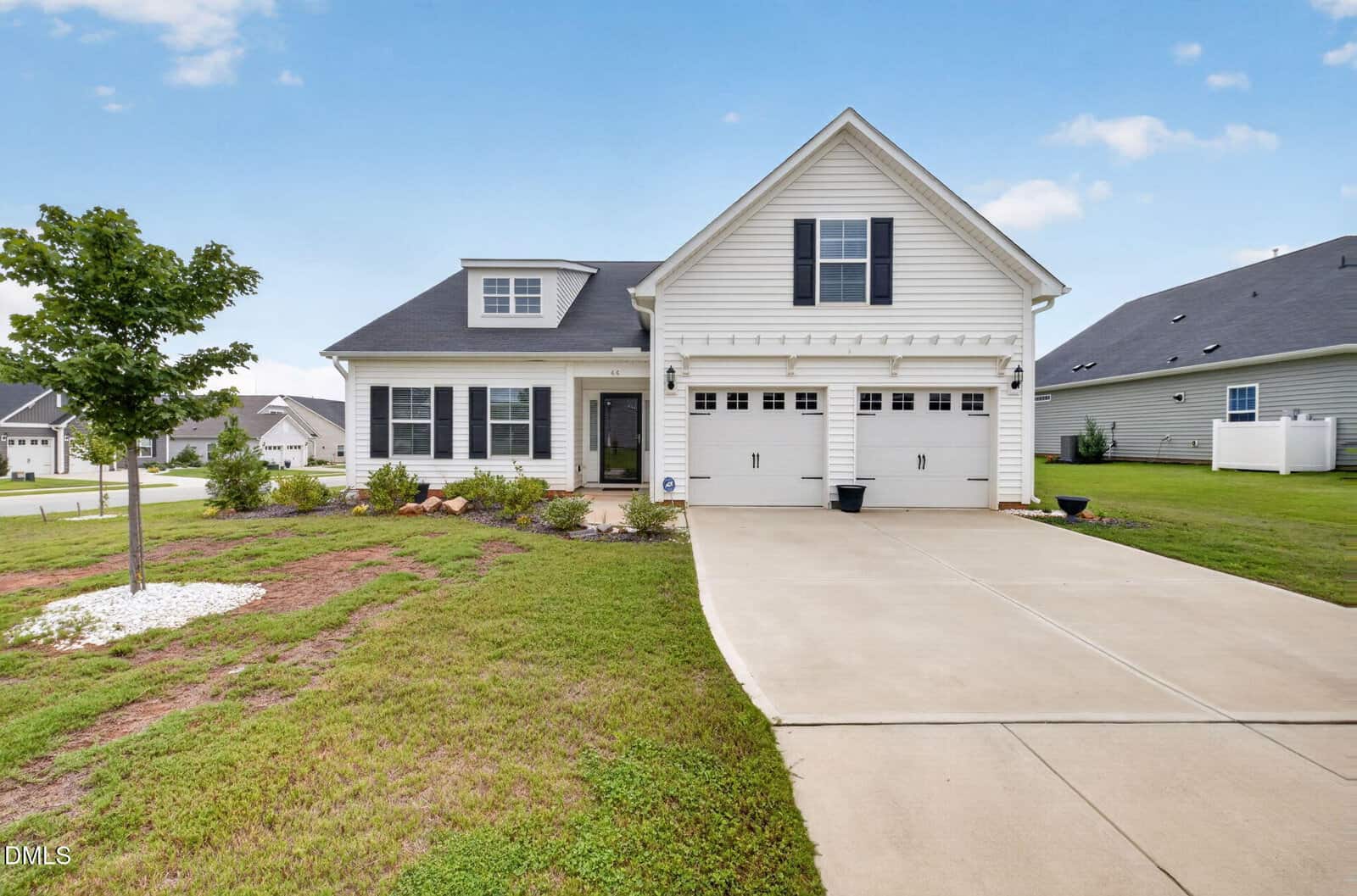 A white single-story suburban house at 44 Heartleaf Square, Youngsville, features a double garage, concrete driveway, small front porch, and a landscaped yard with a young tree and green grass under a clear sky.