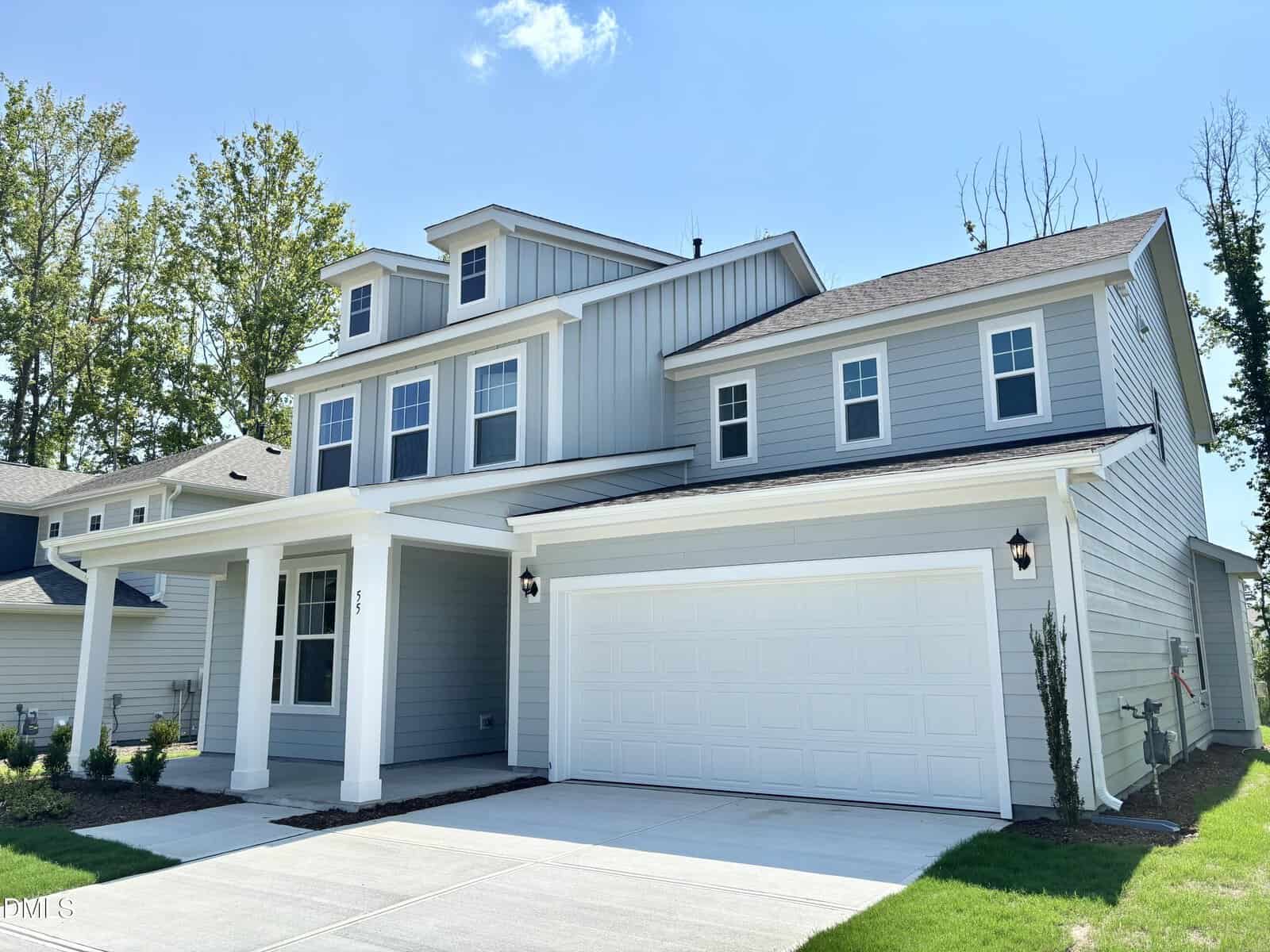 Two-story modern suburban house at 55 Sugar Pine Drive, Franklinton, featuring light gray siding, white trim, and a two-car garage. There is a covered front porch supported by columns. The driveway and walkway are concrete, and the lawn is neatly landscaped.