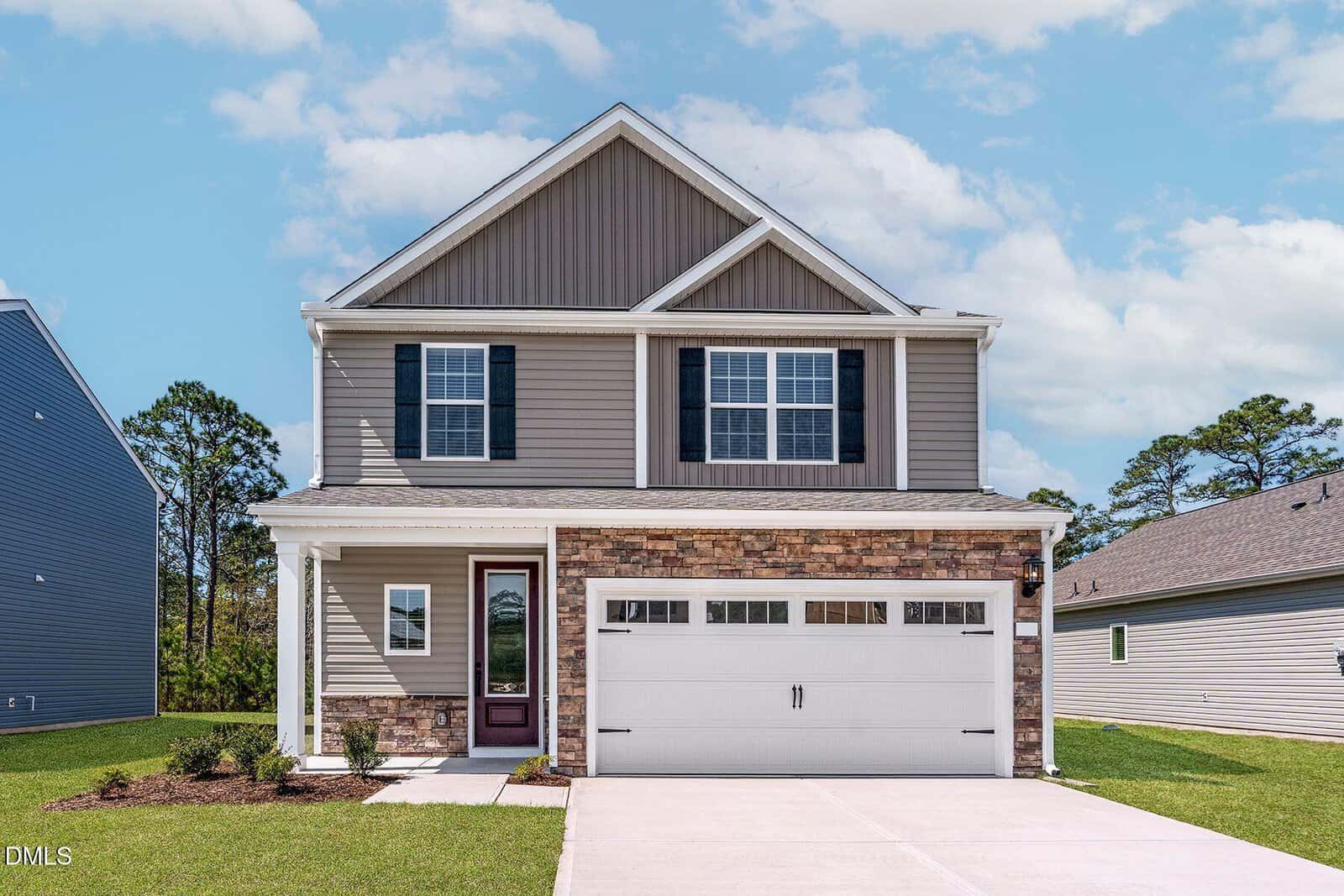 Located at 35 Saddle Way in Youngsville, this two-story suburban house features beige siding, stone accents, and a white double garage door. The front yard has minimal landscaping and a concrete driveway. The sky is partly cloudy, with other houses visible nearby.