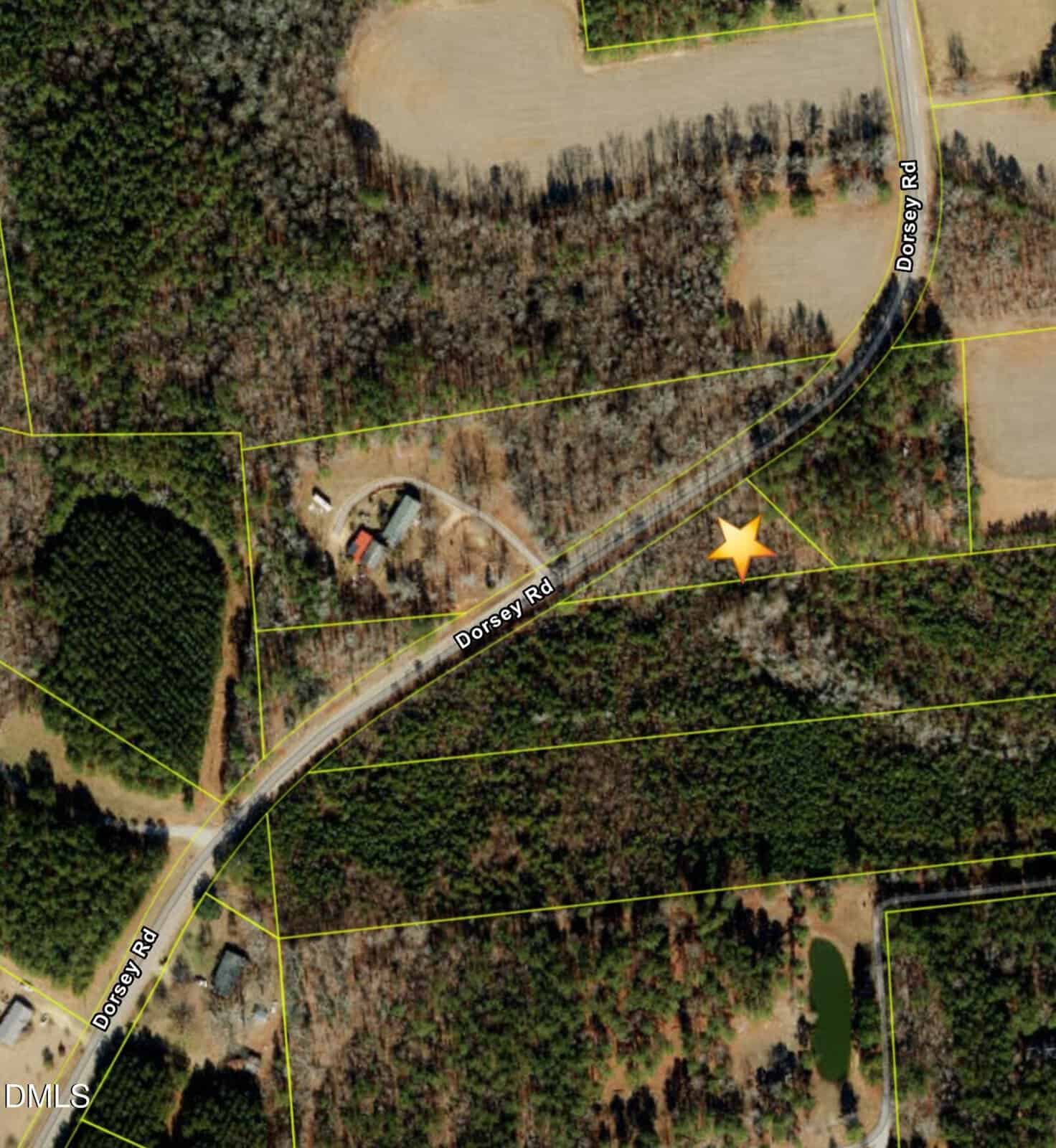 Aerial view of 0 Dorsey Road curving through wooded and cleared areas near Louisburg, with property boundary lines visible; a yellow star marks a location near the road, and several buildings and ponds are scattered nearby.