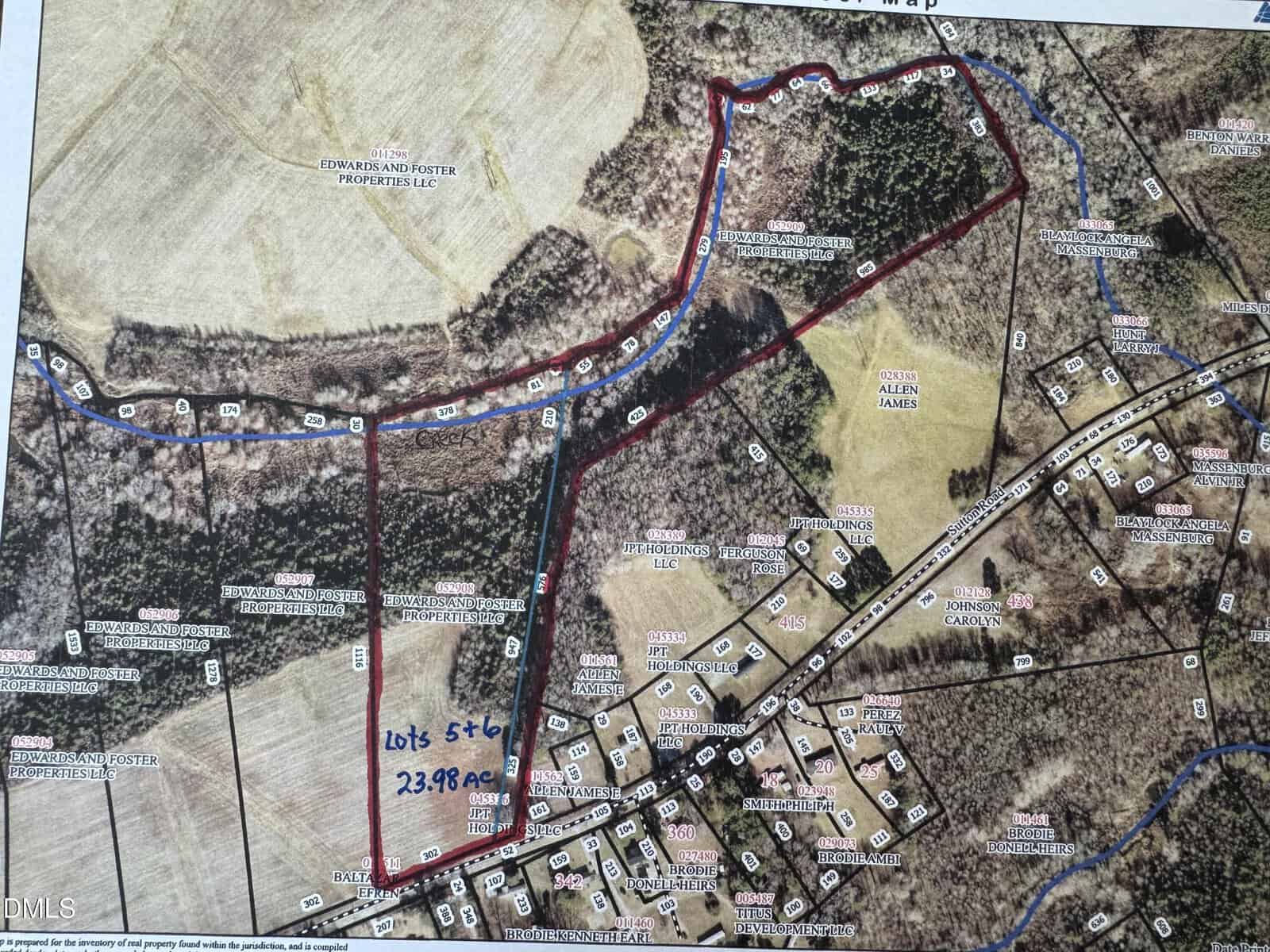 A color-coded map shows lots 5 and 6 outlined in red, totaling 23.98 acres. The lots include wooded and cleared areas, bordered by residential plots, roads, and labeled nearby parcels.