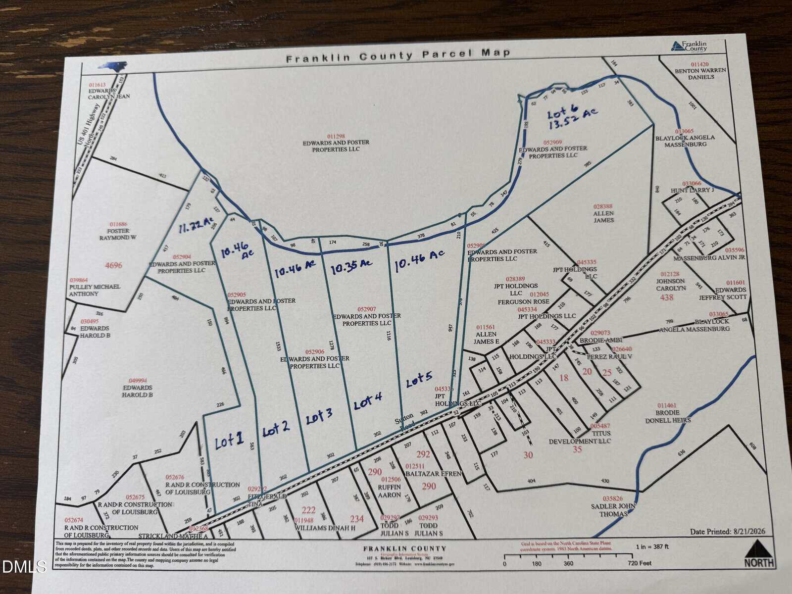 Franklin County parcel map showing subdivided lots outlined in blue, with acreage totals written in blue ink. Roads, parcel numbers, and owners’ names are labeled throughout the map. North arrow and scale visible at the bottom.
