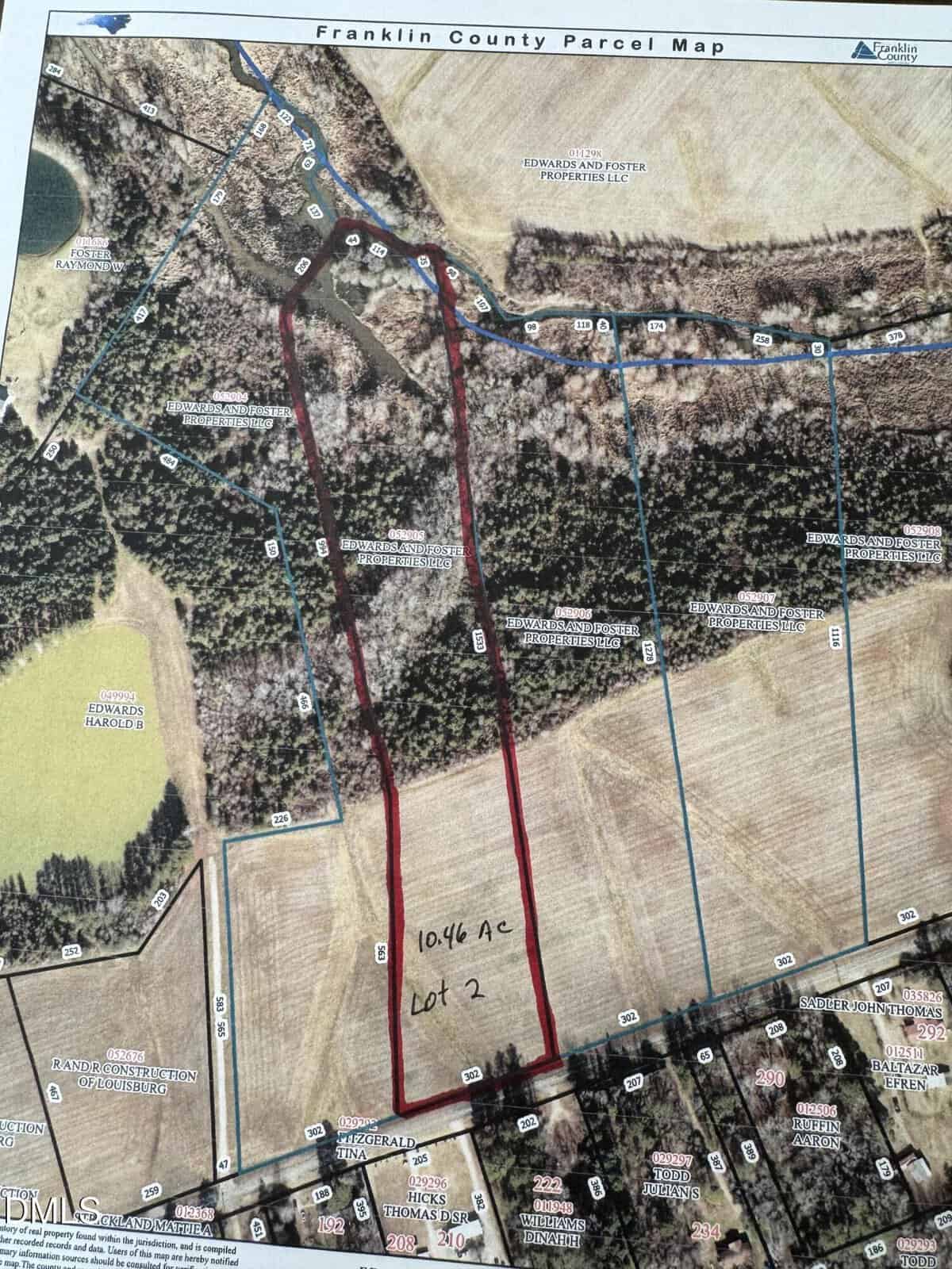 Aerial map of Franklin County showing outlined property boundaries. A rectangular lot, labeled “10.46 ac Lot 2,” is highlighted in red, featuring fields, woods, and bordering roads and parcels with numeric markers.