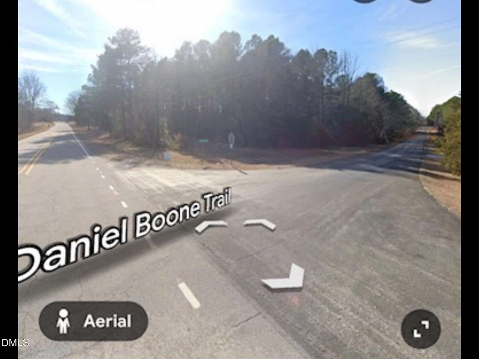 A sunny intersection of Daniel Boone Trail near a wooded area, with multiple roads and shadows of tall trees. The words “Daniel Boone Trail” and “Aerial” appear on the image.