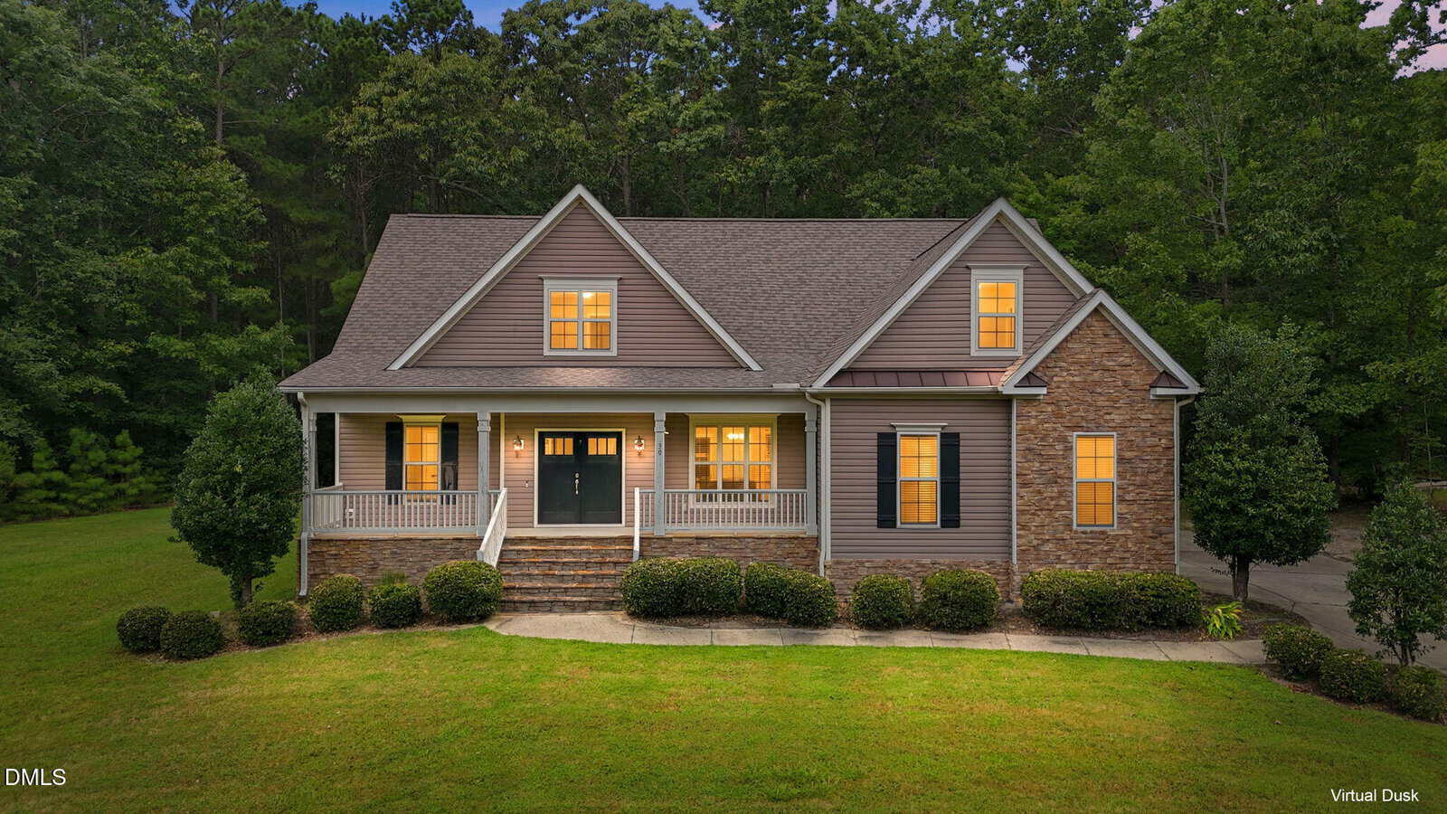 A two-story suburban house at 30 Banbury Road W, Zebulon, with lit windows, a front porch, stone and siding exterior, surrounded by trees and a green lawn at dusk.