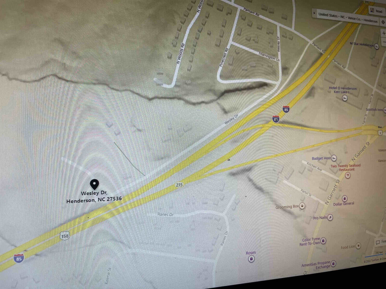 A screenshot of a digital map displaying a section of henderson, nc, with streets and landmarks labeled, and a specific address at wesley dr. highlighted.